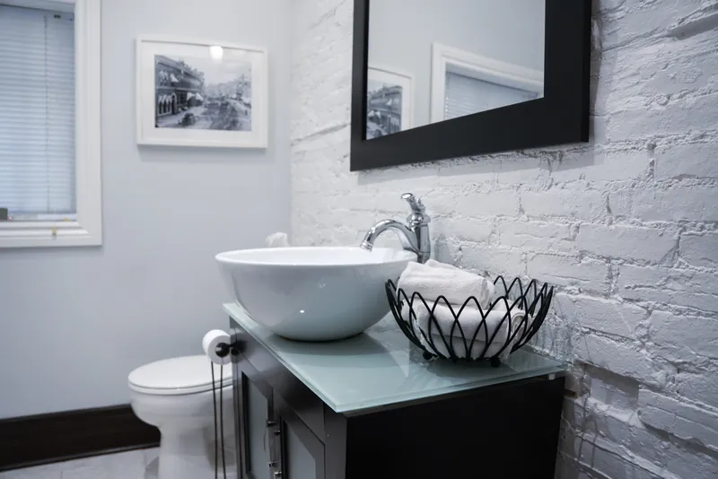 Main-floor washroom with white-brick wall
